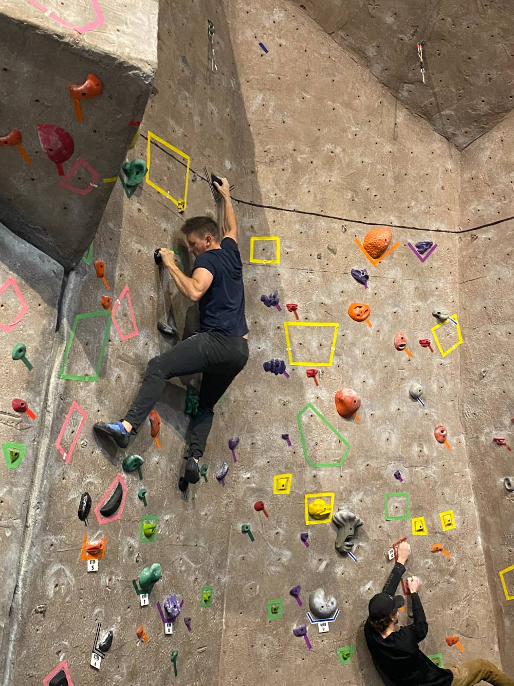 competitor on a hard, crimpy route